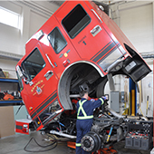 Fire mechanic working on firetruck