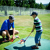 Boy getting golf lessons