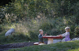 Two young children in natural play area of Emily Carr Park