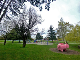 panoramic picture showing trees surrounding the pink elephant and playground in the background